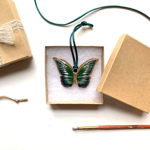 green blue gold butterfly ornament in gift box