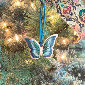 green blue gold butterfly ornament on christmas tree