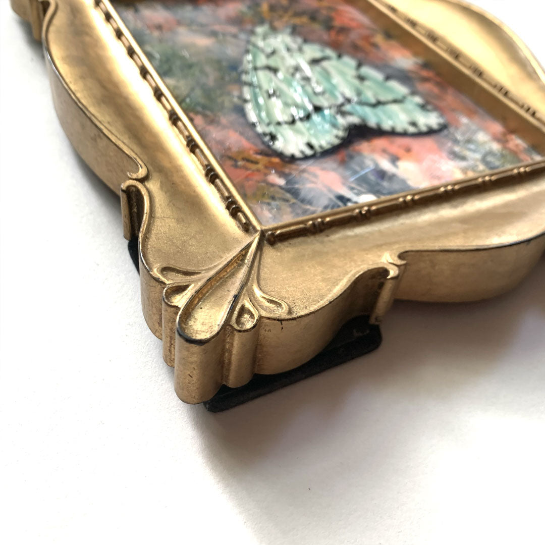 green marvel moth painting gold frame detail