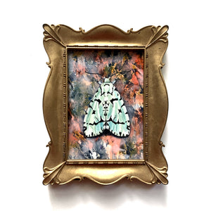 green marvel moth painting in gold frame