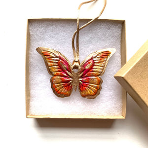 pink, orange, gold butterfly ornament in gift box