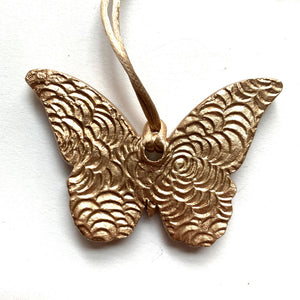 Rust, pink, gold butterfly ornament back texture