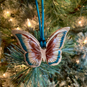 rust gold teal butterfly ornament on tree