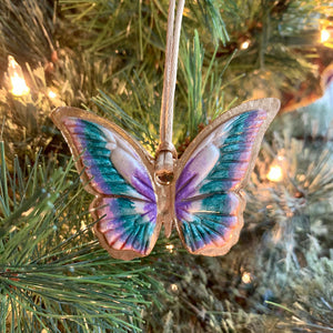 teal, purple, blush, gold butterfly ornament on tree